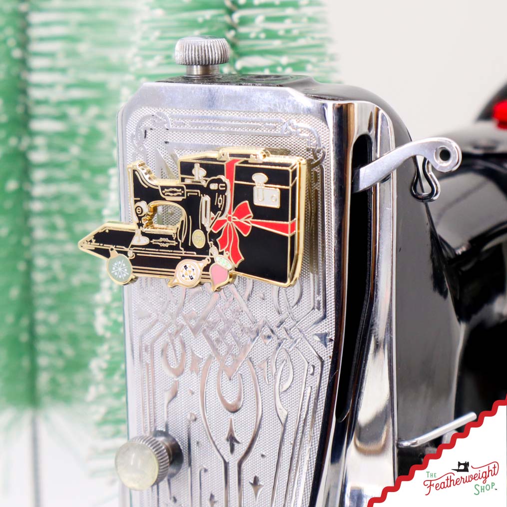 Pin Pal Christmas Present needle minder shown on the Featherweight faceplate