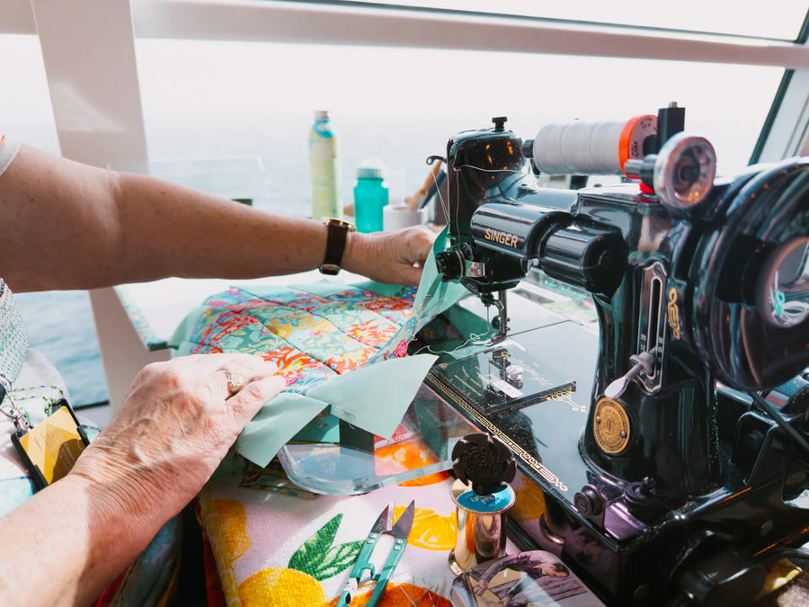 Hands piecing a quilt block