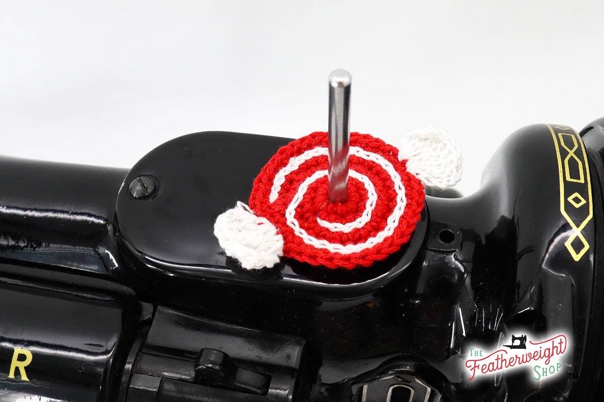 Peppermint Red spool pin doily shown on the machine