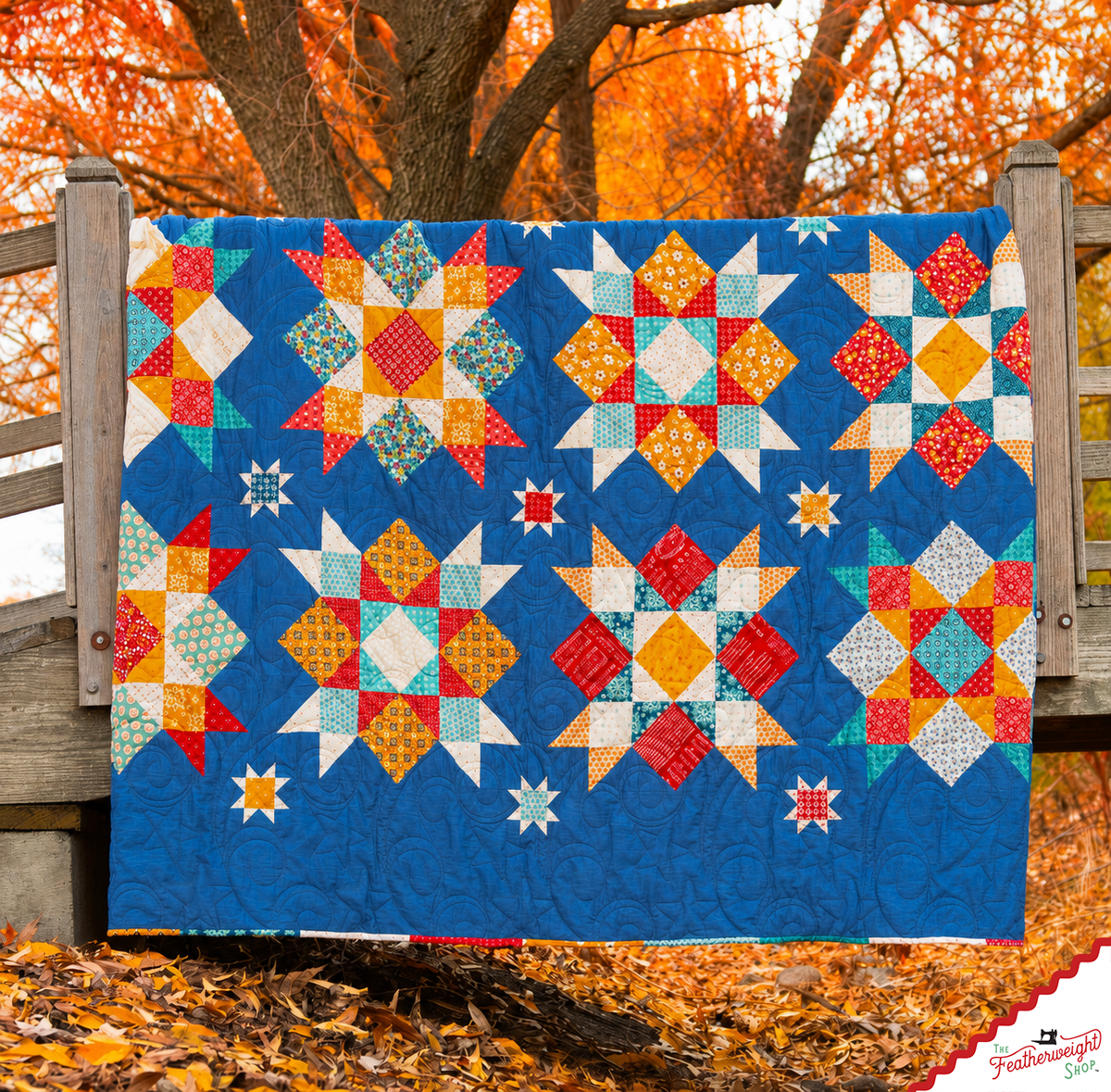 Finished quilt draped over a wooden fence