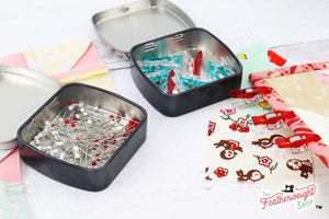 Featherweight pin tin box holding pins and wonder clips