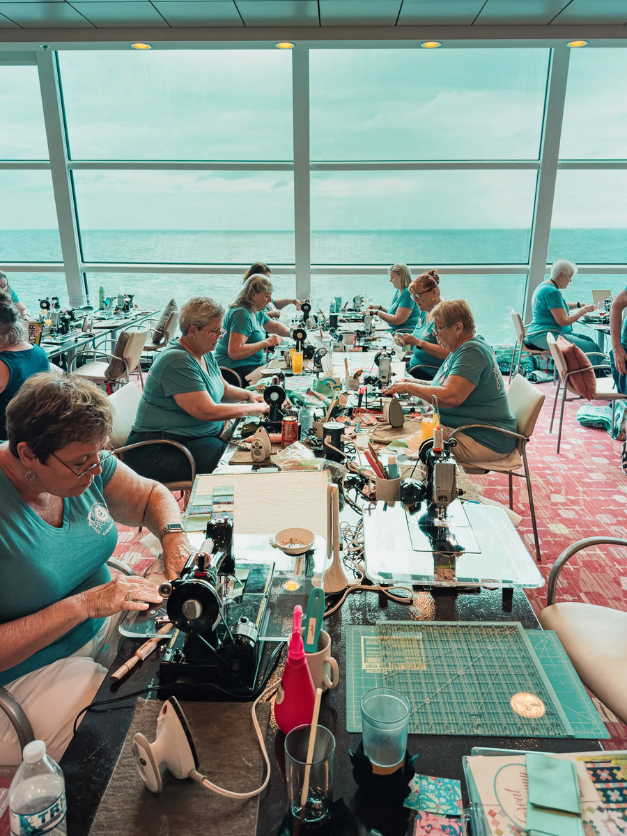 Quilters sewing together aboard ship