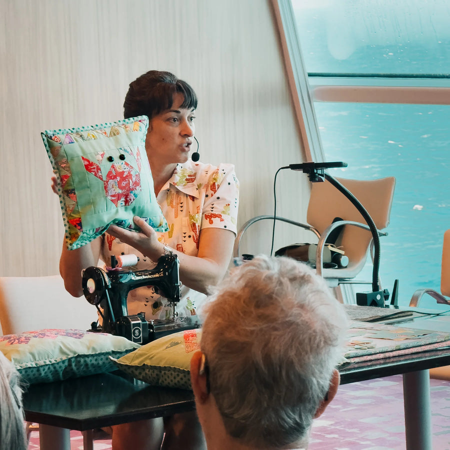 Instructor teaching a quilting class aboard ship