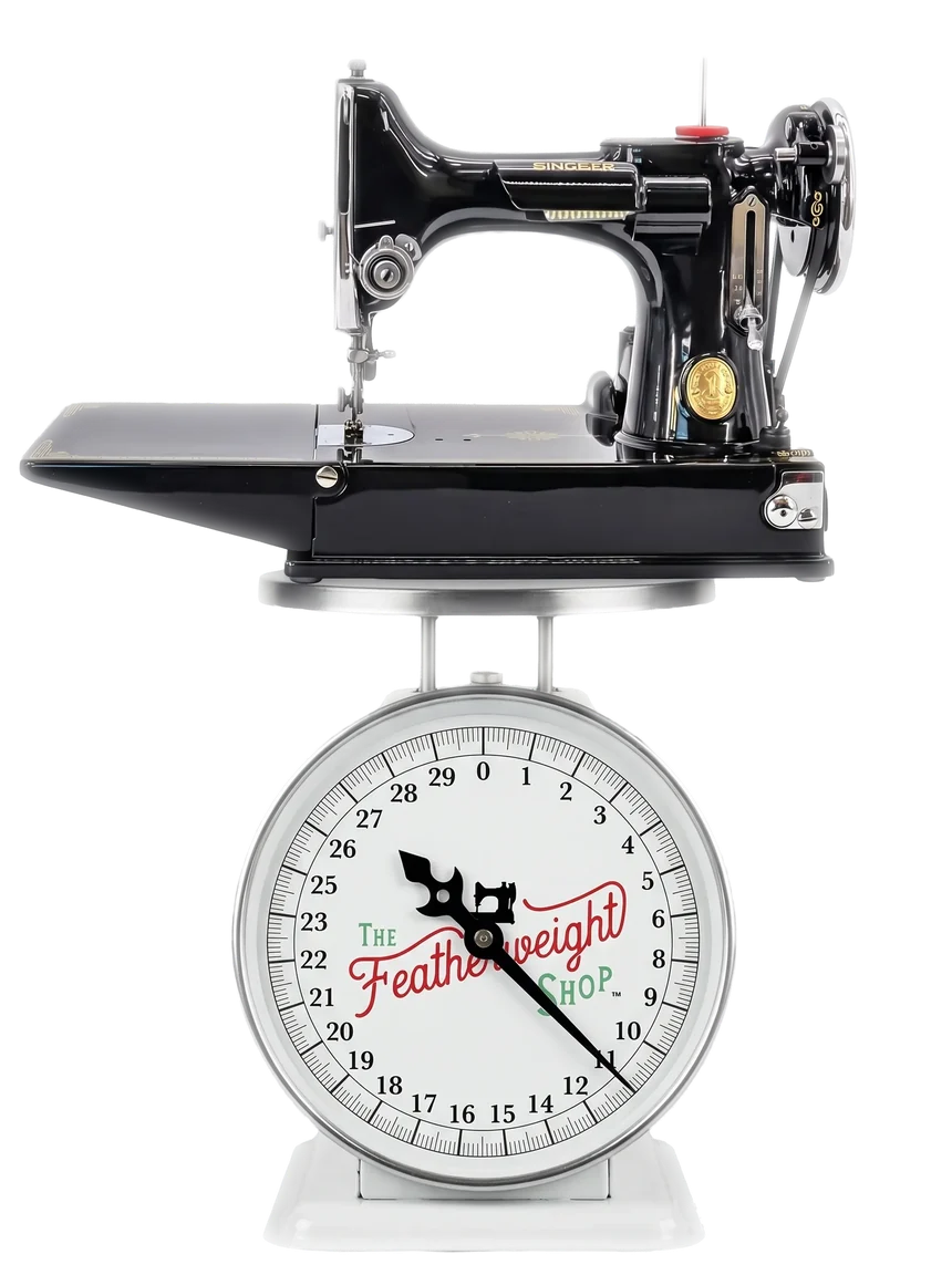 A Singer Featherweight resting on a Featherweight Shop scale